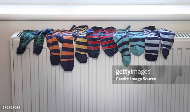 socks drying on radiator - pair stock photos et images de collection