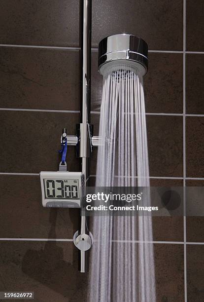 shower with timer and running water - timer stock pictures, royalty-free photos & images