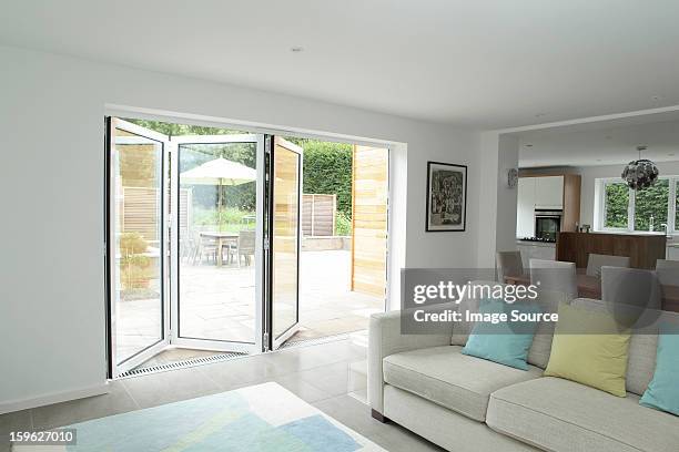 open plan living area with open patio doors - foldable stock pictures, royalty-free photos & images