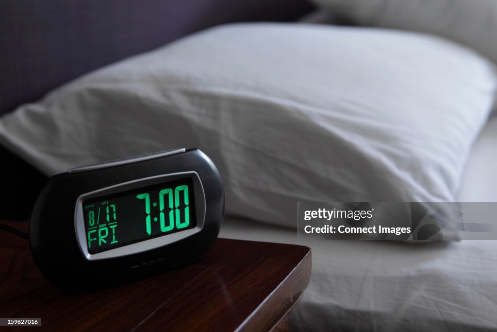 Alarm clock by bed