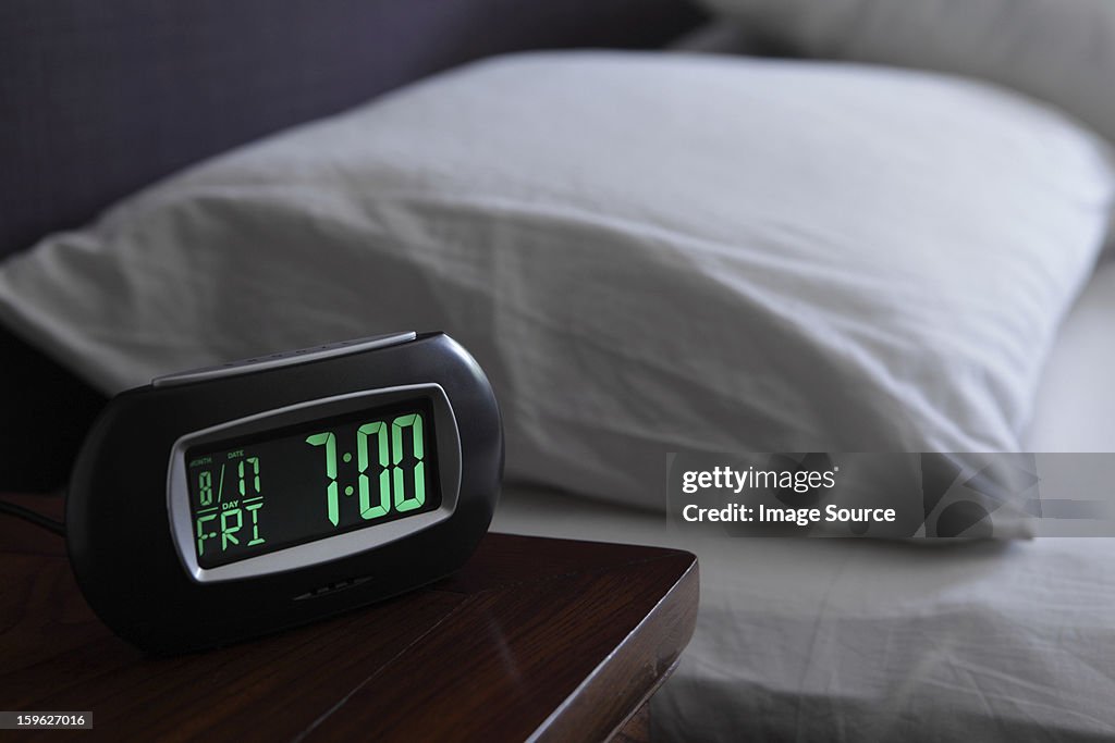 Alarm clock by bed