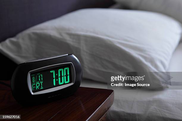 alarm clock by bed - digital clock - fotografias e filmes do acervo