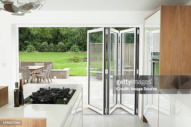 kitchen with open patio doors - foldable stock pictures, royalty-free photos & images