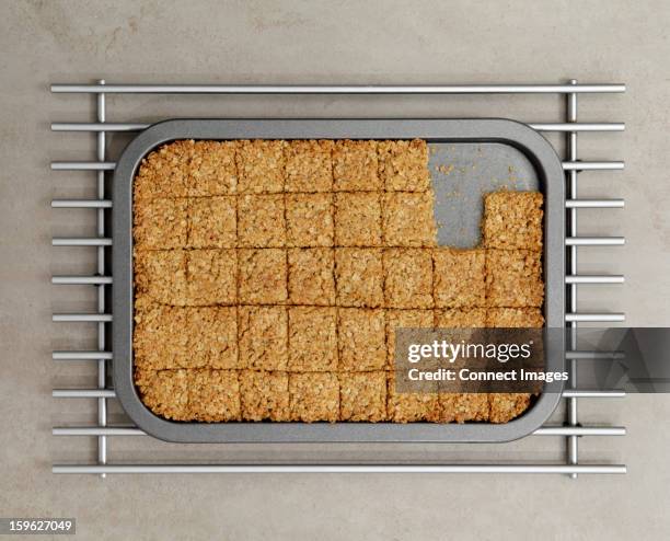 tray of flapjacks with some missing - flapjack stock pictures, royalty-free photos & images