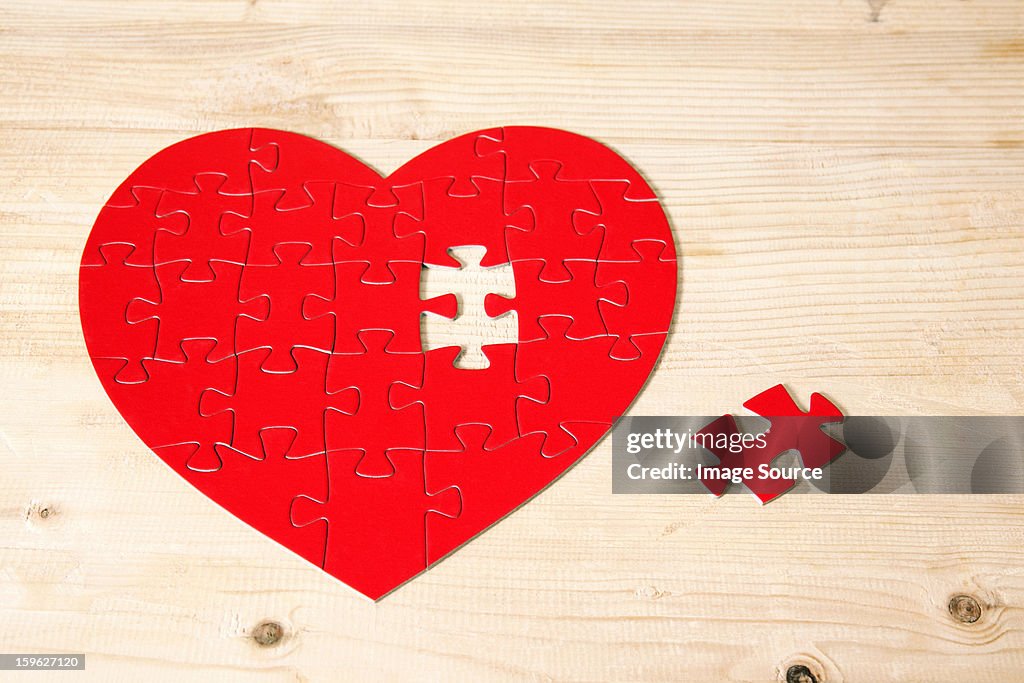 Heart shaped jigsaw puzzle with missing piece