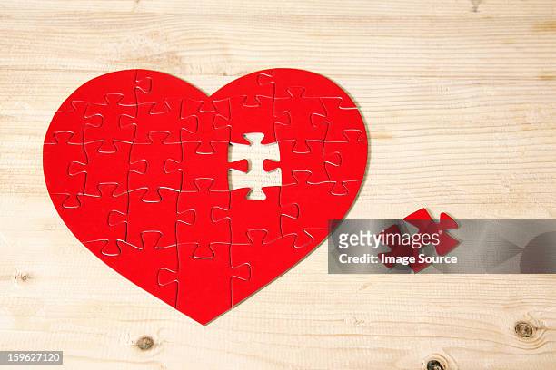 heart shaped jigsaw puzzle with missing piece - lastra a signa stock pictures, royalty-free photos & images