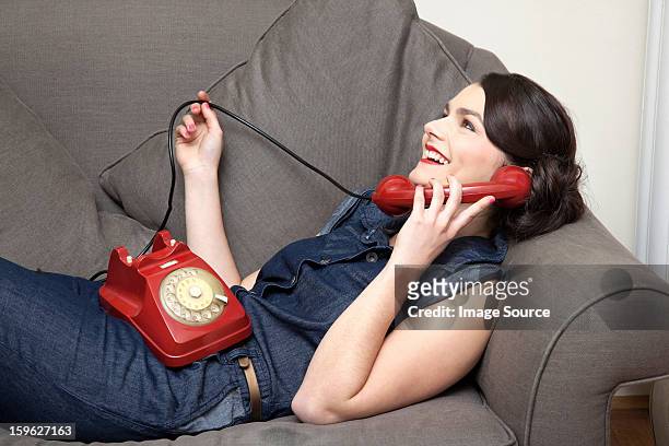 woman on sofa on the phone - lastra a signa stock pictures, royalty-free photos & images