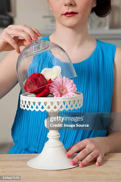 woman lifting lid of cake stand with flowers - lastra a signa stock pictures, royalty-free photos & images