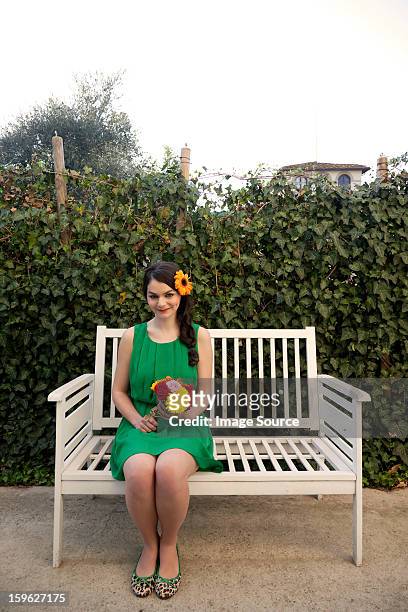woman on bench holding flowers - lastra a signa stock pictures, royalty-free photos & images