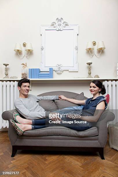couple on sofa - lastra a signa stock pictures, royalty-free photos & images