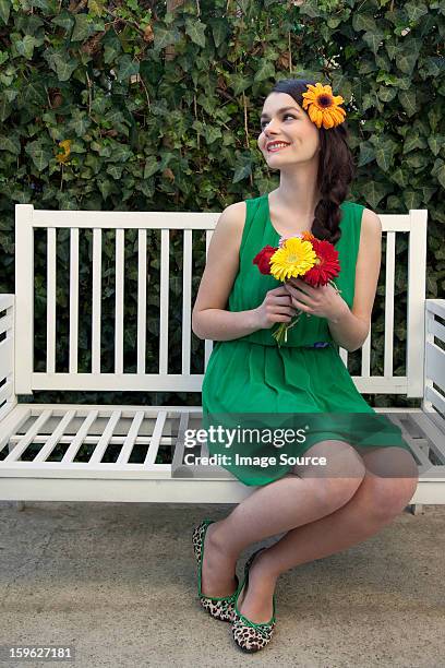 woman on bench holding flowers - lastra a signa stock pictures, royalty-free photos & images