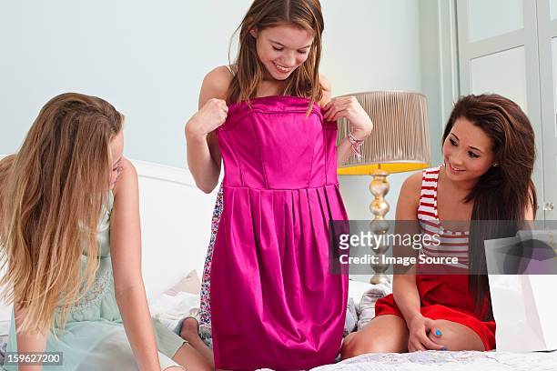teenage girl showing dress to friends - prom dress stock pictures, royalty-free photos & images