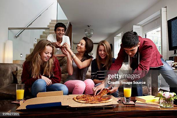 teenagers having take away pizza - share house stock pictures, royalty-free photos & images