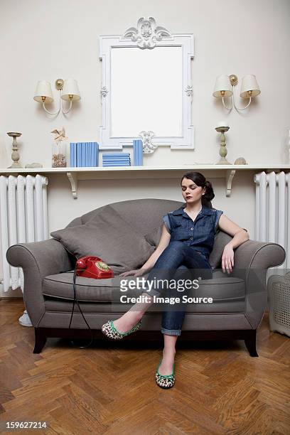 woman on sofa with telephone - lastra a signa stock pictures, royalty-free photos & images