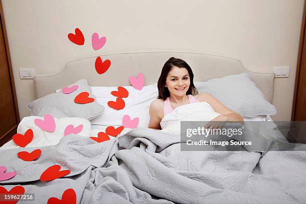 woman in bed with heart shapes on bedclothes - lastra a signa stock pictures, royalty-free photos & images