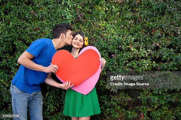 couple holding heart shape, man kissing woman - lastra a signa stock pictures, royalty-free photos & images