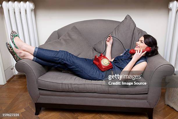 woman on sofa on the phone - lastra a signa stock pictures, royalty-free photos & images