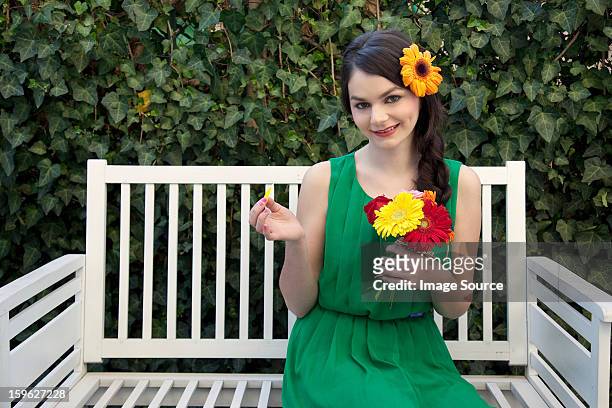 woman on bench holding flowers - lastra a signa stock pictures, royalty-free photos & images