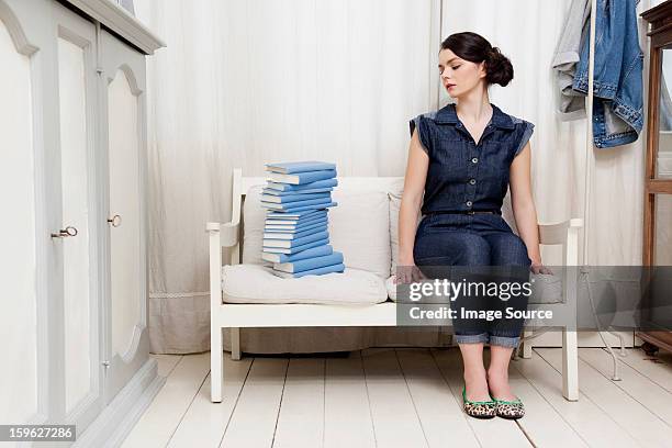 woman staring at stack of books - lastra a signa stock pictures, royalty-free photos & images