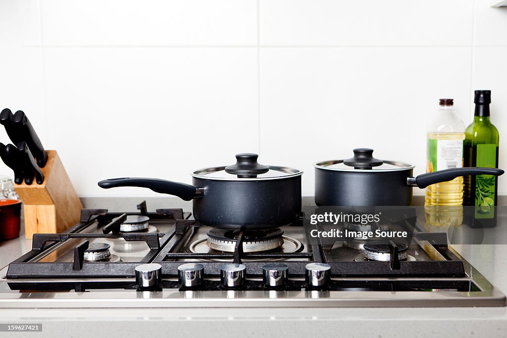 Saucepans on gas hob