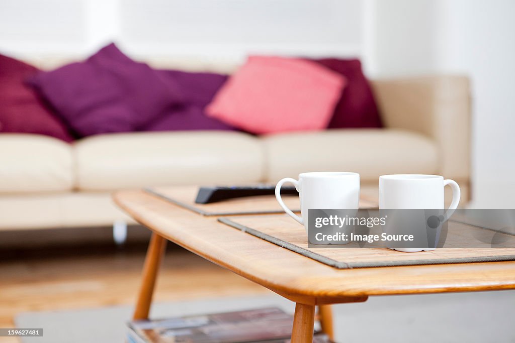 Two coffee cups on coffee table