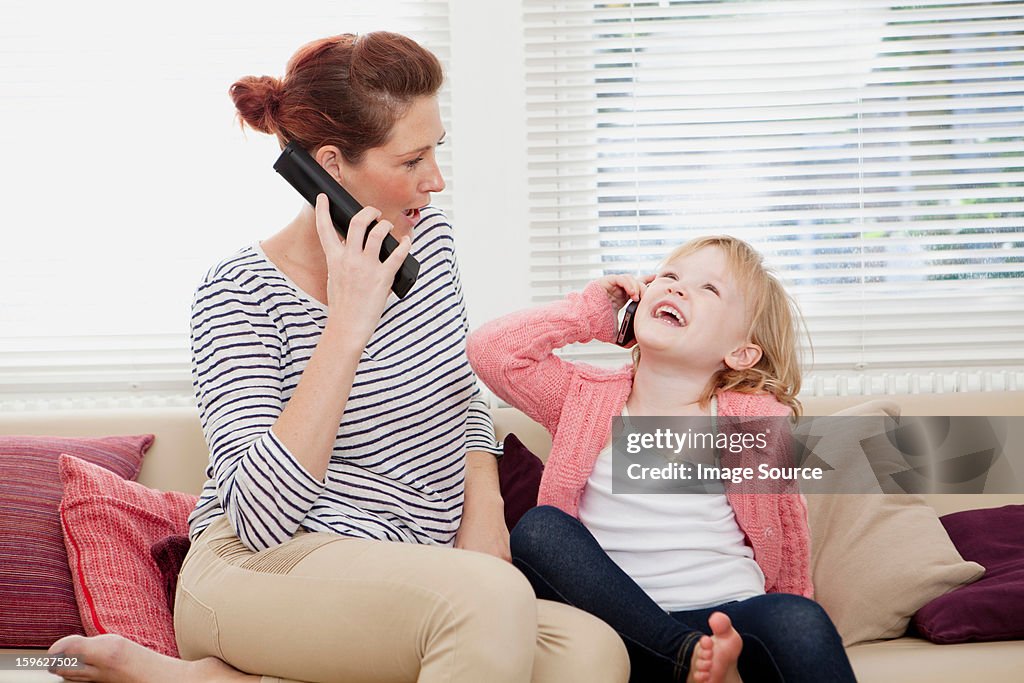 Mother and daughter on cell phones