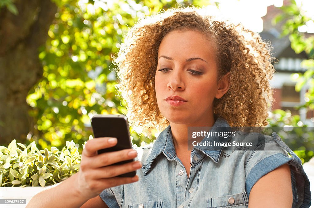 Woman holding cell phone