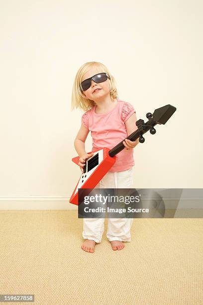 toddler wearing sunglasses, playing guitar - girls on white background stock pictures, royalty-free photos & images