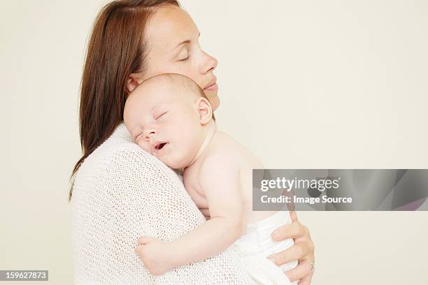 mother with newborn baby sleeping on shoulder - adults wearing cloth diapers ストックフォトと画像