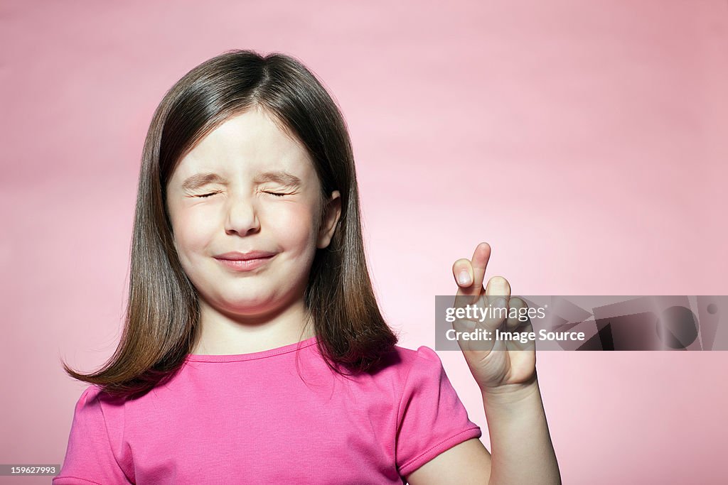 Girl with fingers crossed