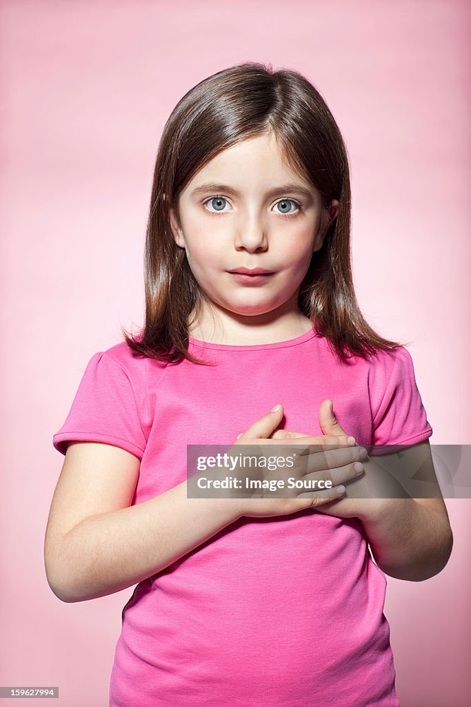 Girl with hands on heart