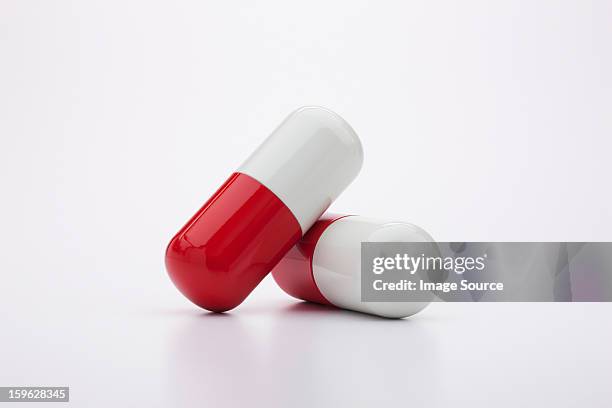 two capsules - twee objecten stockfoto's en -beelden