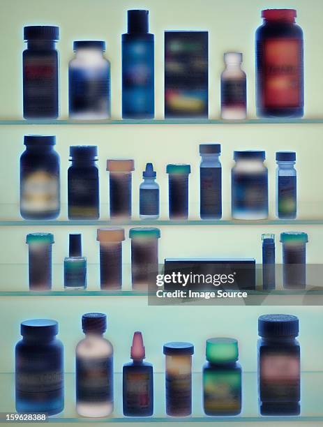 medicine bottles in cabinet - armoire de toilette photos et images de collection