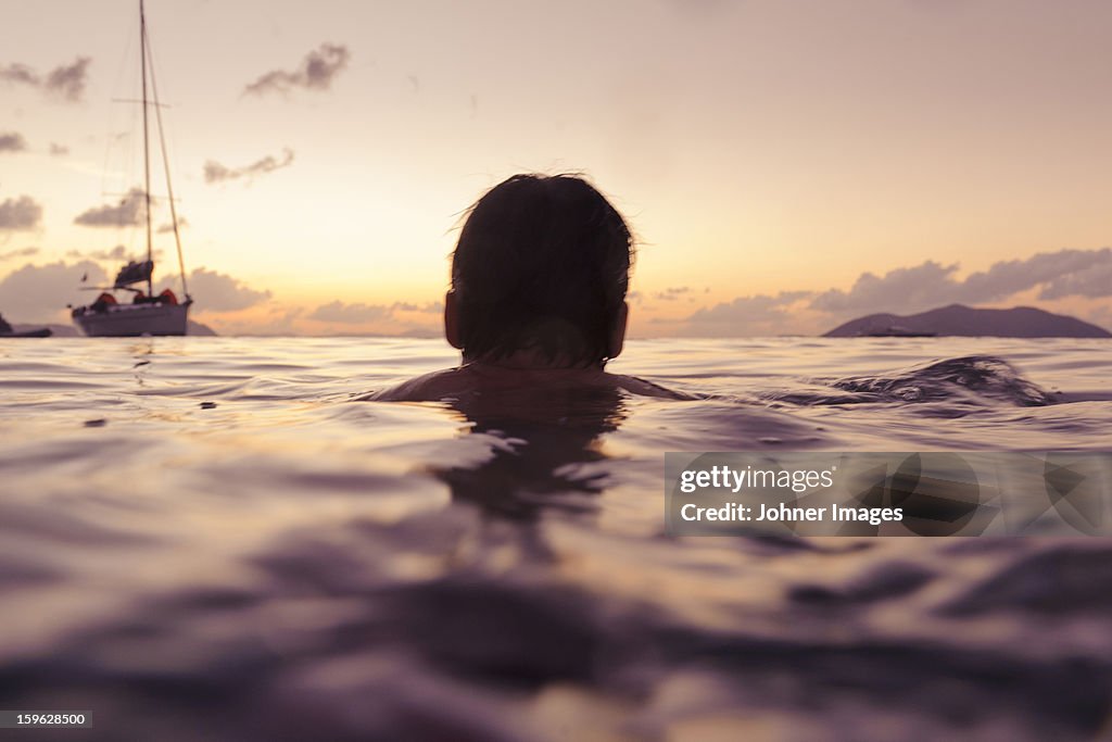 Silhouette of man swimming in sea