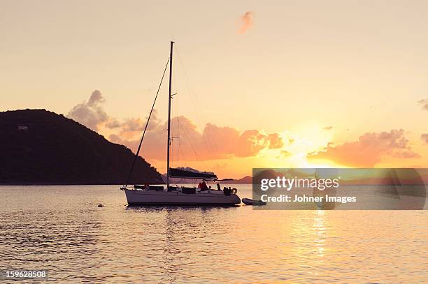 sailing boat against sunset - virgin islands stock pictures, royalty-free photos & images