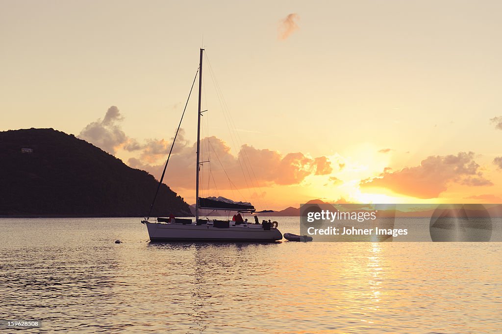 Sailing boat against sunset