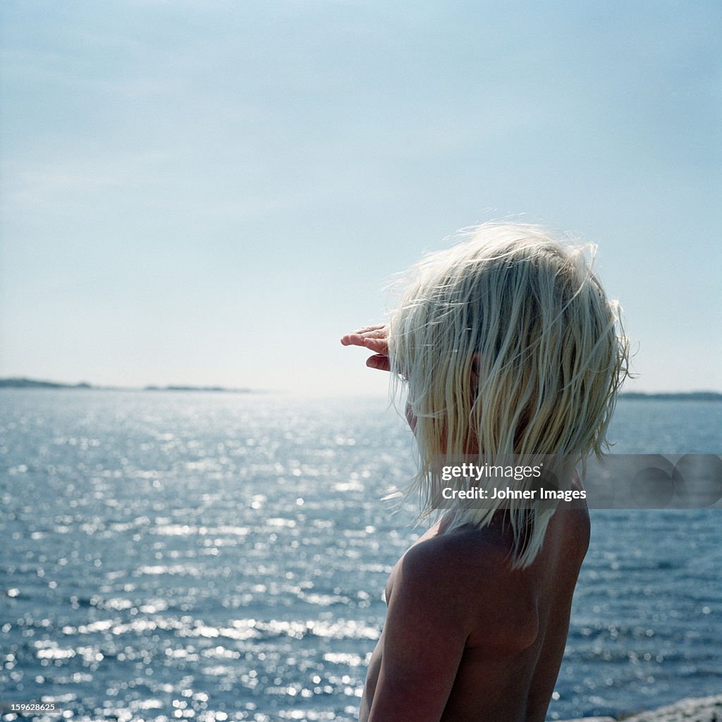 Girl standing by the ocean, Blekinge, Sweden.