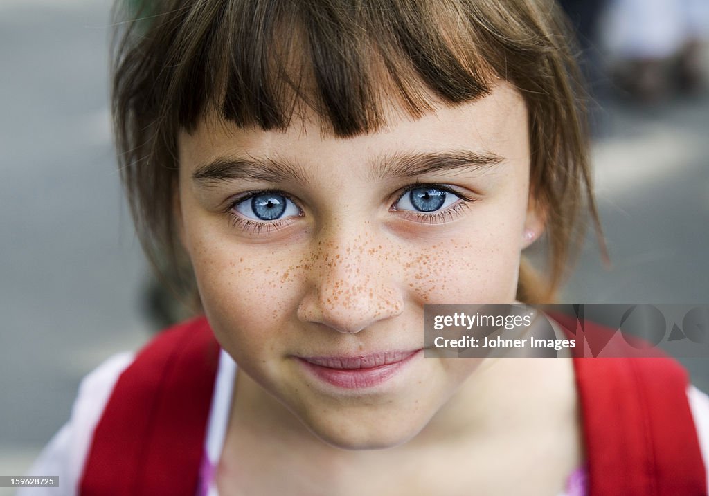 Portrait of a girl with big blue eyes and freckles, Sweden.