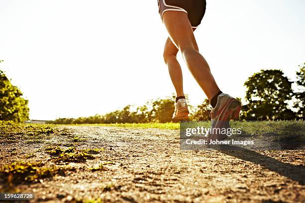 young woman running, sweden. - running legs ストックフォトと画像