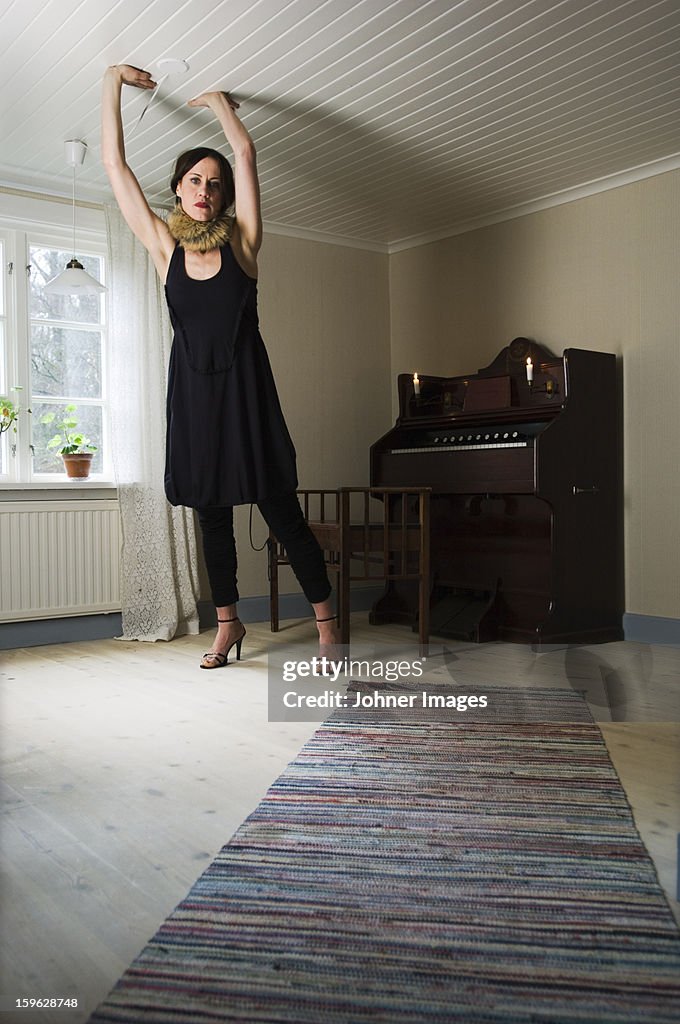 Woman in a room that is too small in dimensions, Sweden.