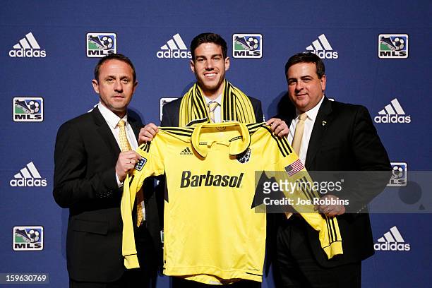 Drew Beckie of the University of Denver poses for photos with team officials after being selected by the Columbus Crew as the 28th overall pick in...