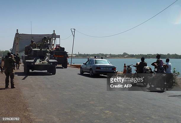 French soldiers in a Sagaie tank from the 21st Rima arrive to secure the strategic bridge on the Niger river on January 16, 2013 after leaving the...
