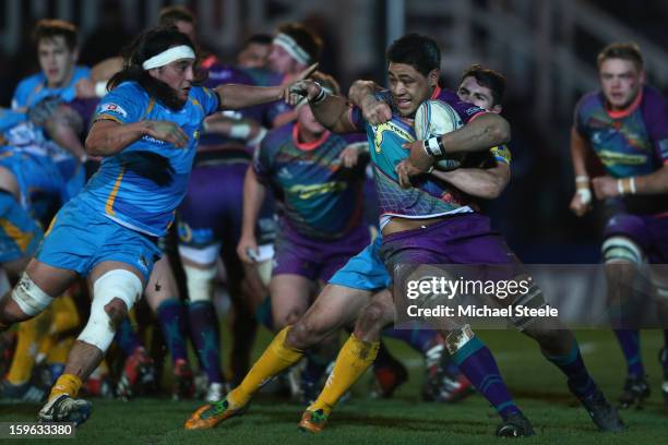 Toby Faletau of Newport Gwent Dragons is held up by Charlie Davies of London Wasps as Jonathan Poff closes in during the Amlin Challenge Cup Pool...