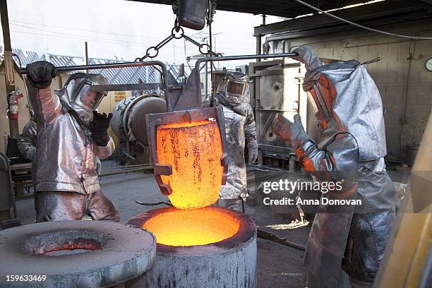 Daniel Flores, Adalid Orozco, Jose Sosa and Enrique Guerrero pour molten bronze metal into molds at the casting of the Screen Actors Guild Award...