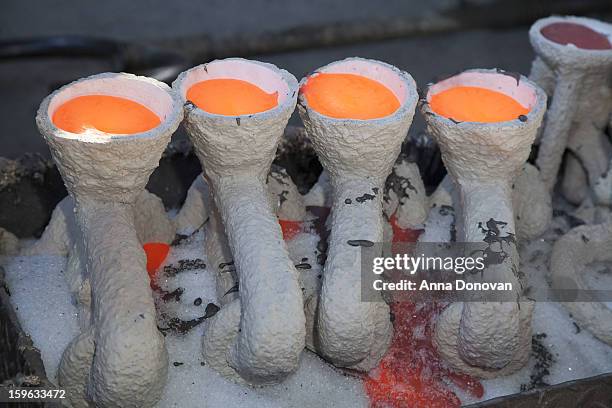 The view on the newly poured molten bronze metal inside the molds at the casting of the Screen Actors Guild Award statuettes, at the American Fine...