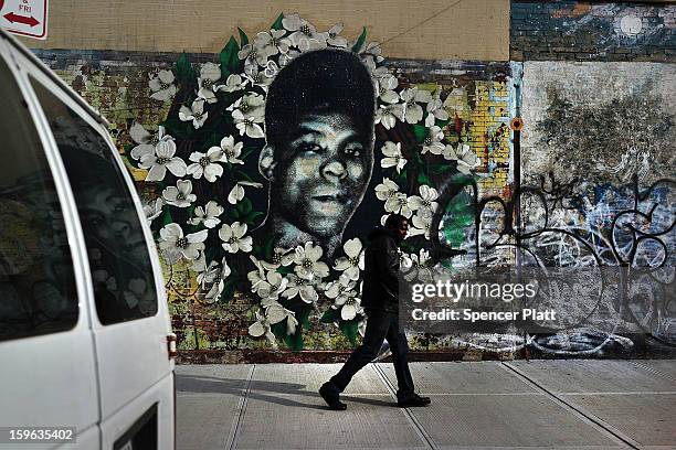 Man walks by a walks by a graffiti memorial in memory of Yusef Hawkins, a 16-year-old African American youth who was shot to death on August 23, 1989...