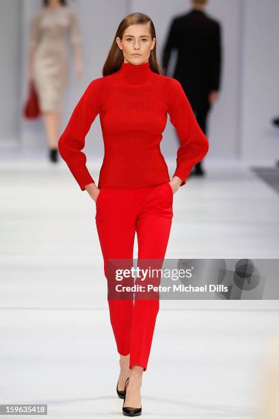 Model walks the runway at Hugo By Hugo Boss Autumn/Winter 2013/14 fashion show during Mercedes-Benz Fashion Week Berlin at Opernwerkstatte on January...