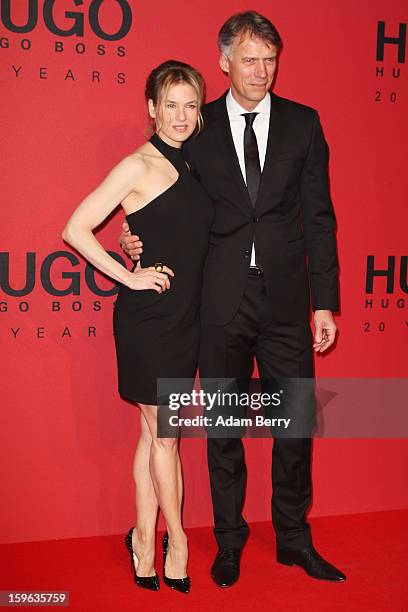 Renee Zellweger and 'Hugo Boss CEO' Claus-Dietrich Lahrs attend Hugo By Hugo Boss Autumn/Winter 2013/14 fashion show during Mercedes-Benz Fashion...