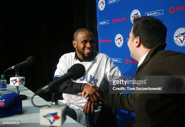Jose Reyes of the Toronto Blue Jays shakes hands with general manager Alex Anthopoulos after concluding the press conference which introduced him to...