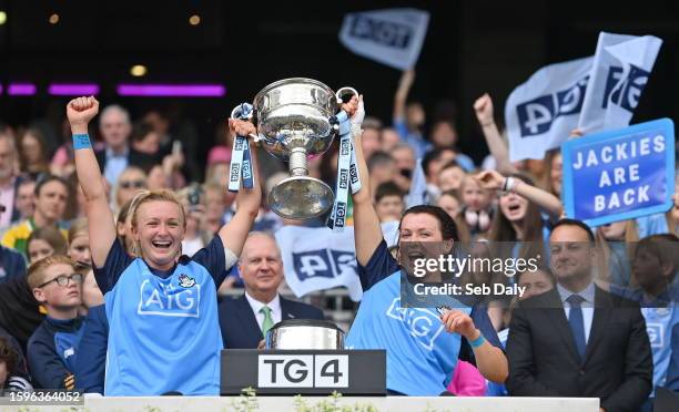 Dublin , Ireland - 13 August 2023; Dublin captain Carla Rowe, left, and teammate Leah Caffrey lift the Brendan Martin Cup after their side's victory...